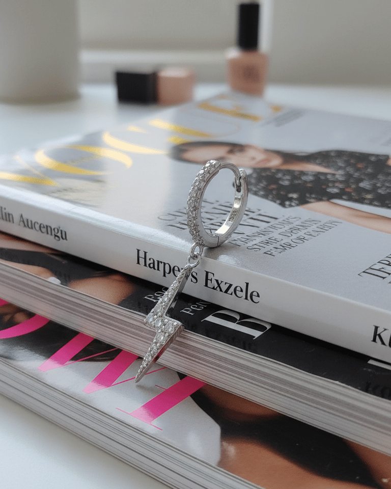 dangling bolt sign hoop earring.