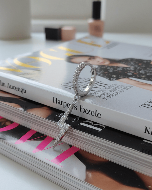 dangling bolt sign hoop earring.