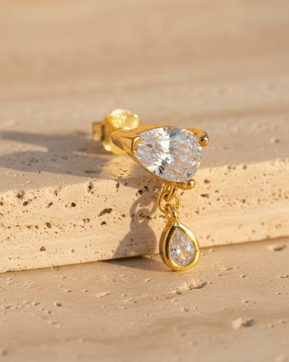 pear shape in prong setting with a dangling smaller pear in bezel setting stud earring.