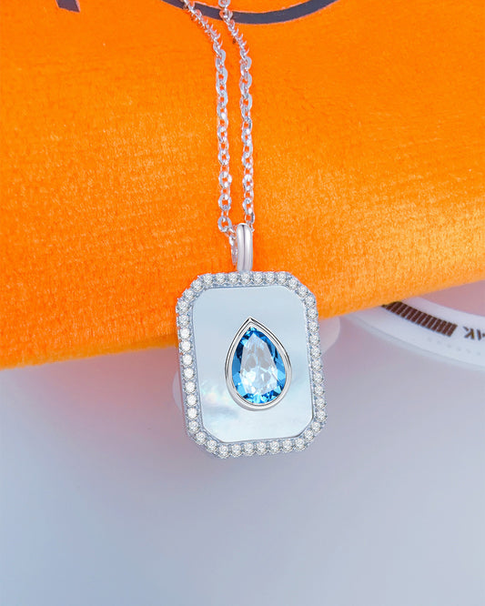 rectangular MOP necklace with pear shape aquamarine color CZ stone.