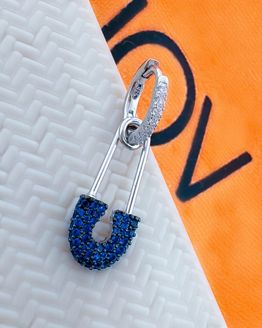 huggie hoop with dangling pin shape.