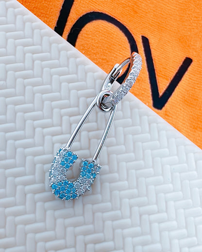 huggie hoop with dangling pin shape.