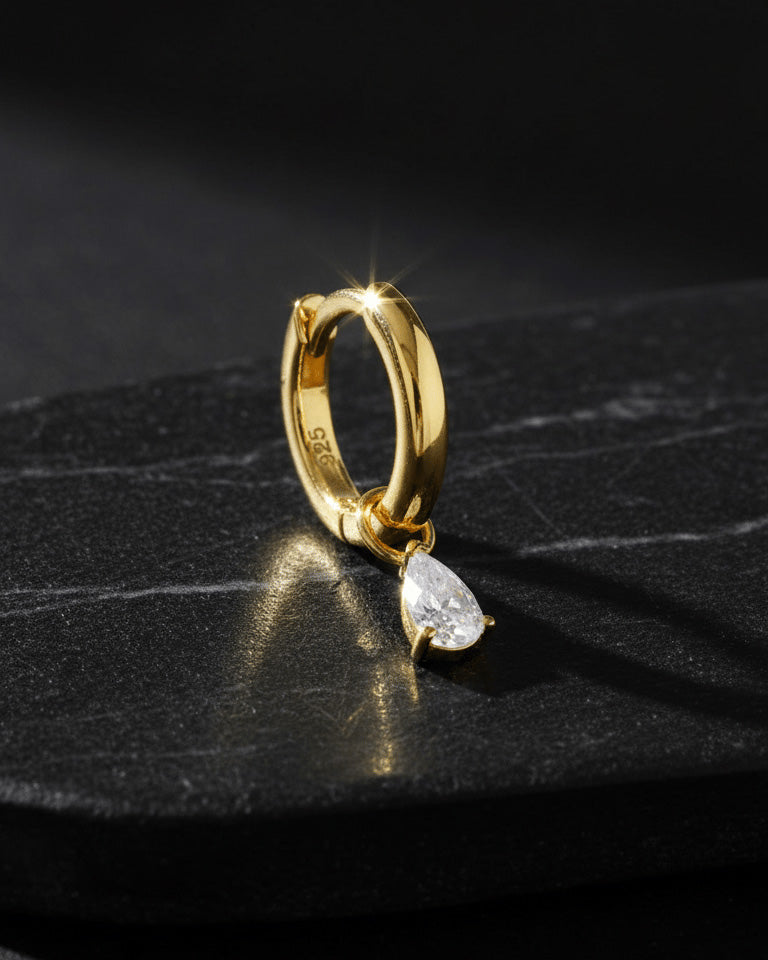 plain golden hoop with removable dangling drop shape stone.