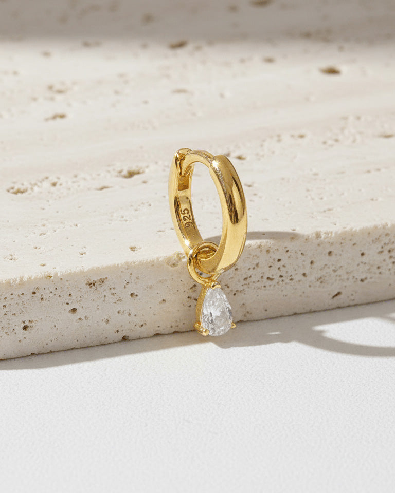 plain golden hoop with removable dangling drop shape stone.