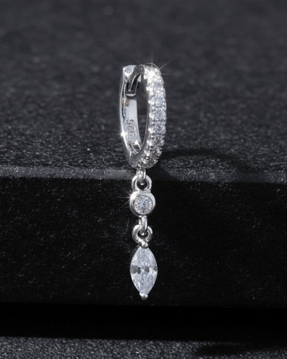CZ huggie hoop with dangling white and emerald color stones.