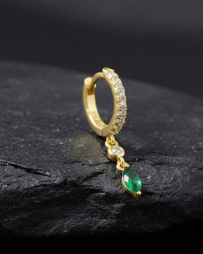 CZ huggie hoop with dangling white and emerald color stones.