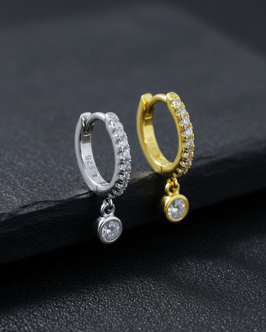 8 mm CZ huggie hoop earring with dangling round stone in bezel setting.