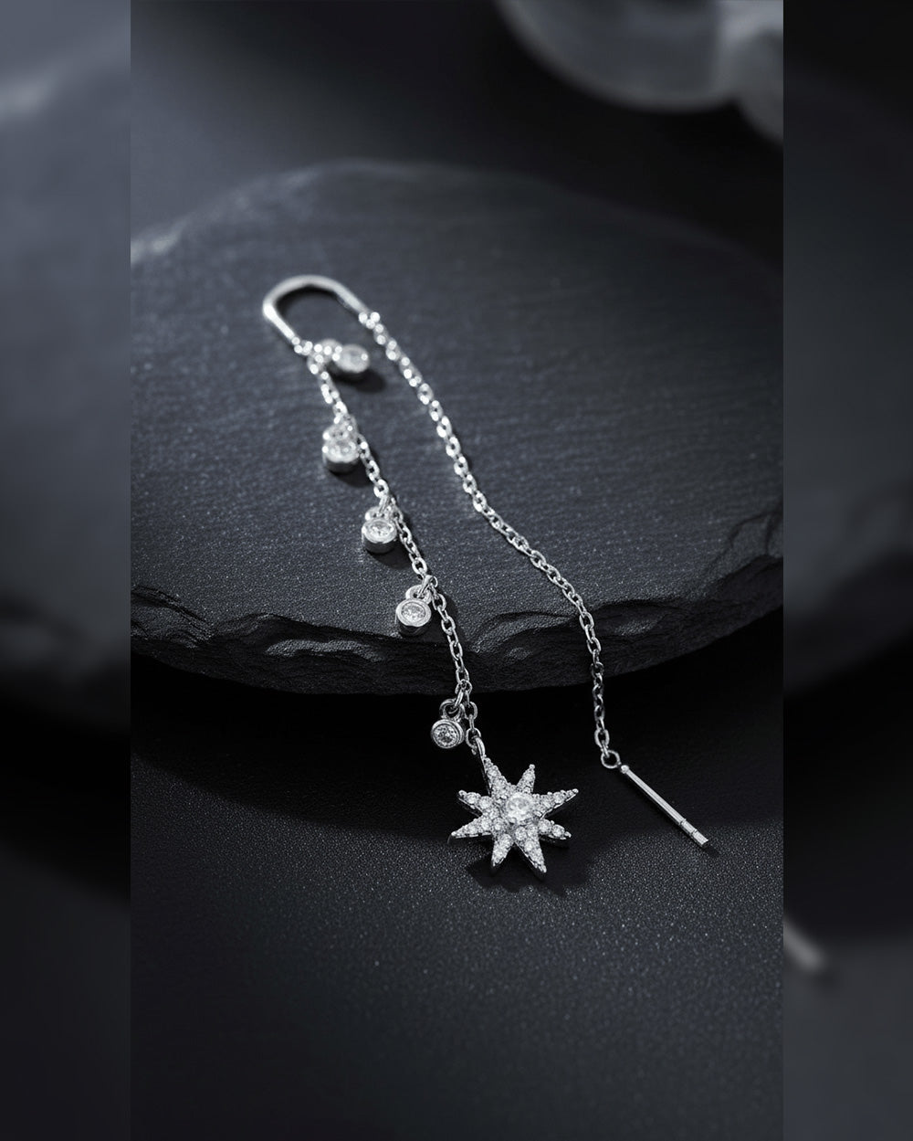 threader star earring with dangling CZ in bezel setting.