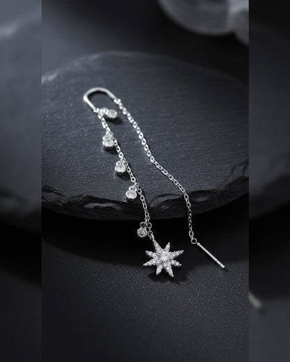threader star earring with dangling CZ in bezel setting.