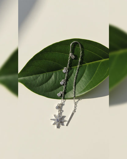 threader star earring with dangling CZ in bezel setting.