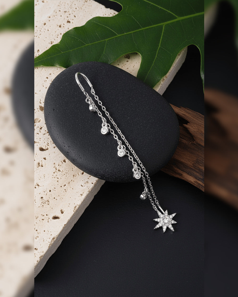 threader star earring with dangling CZ in bezel setting.