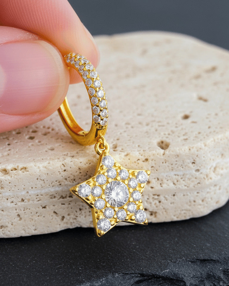 Dangling star hoops earrings.