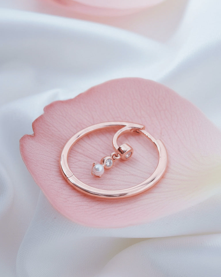 rosegold hoop earring with dangling CZ and pearl.