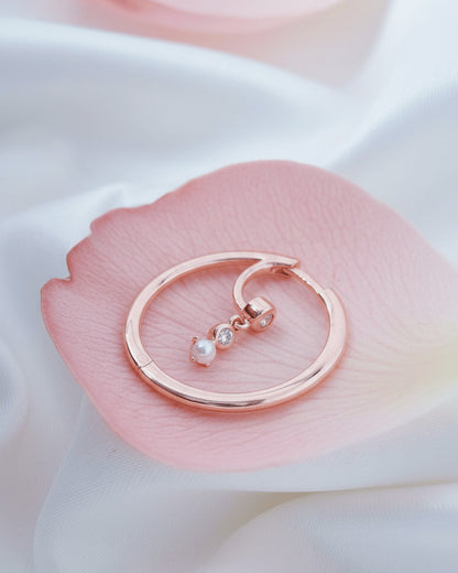 rosegold hoop earring with dangling CZ and pearl.
