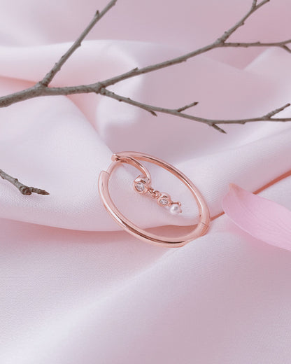 rosegold hoop earring with dangling CZ and pearl.