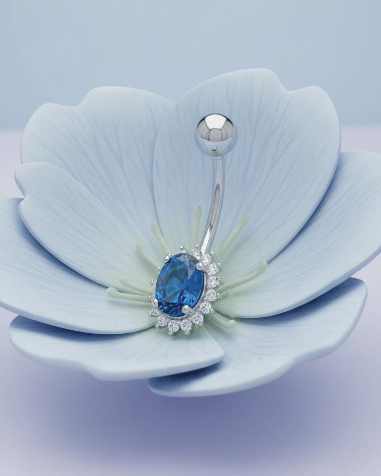 Oval emerald and sapphire color CZ in halo setting belly piercing.