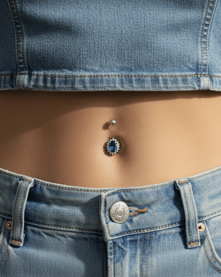 Oval emerald and sapphire color CZ in halo setting belly piercing.