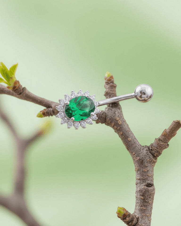 Oval emerald and sapphire color CZ in halo setting belly piercing.