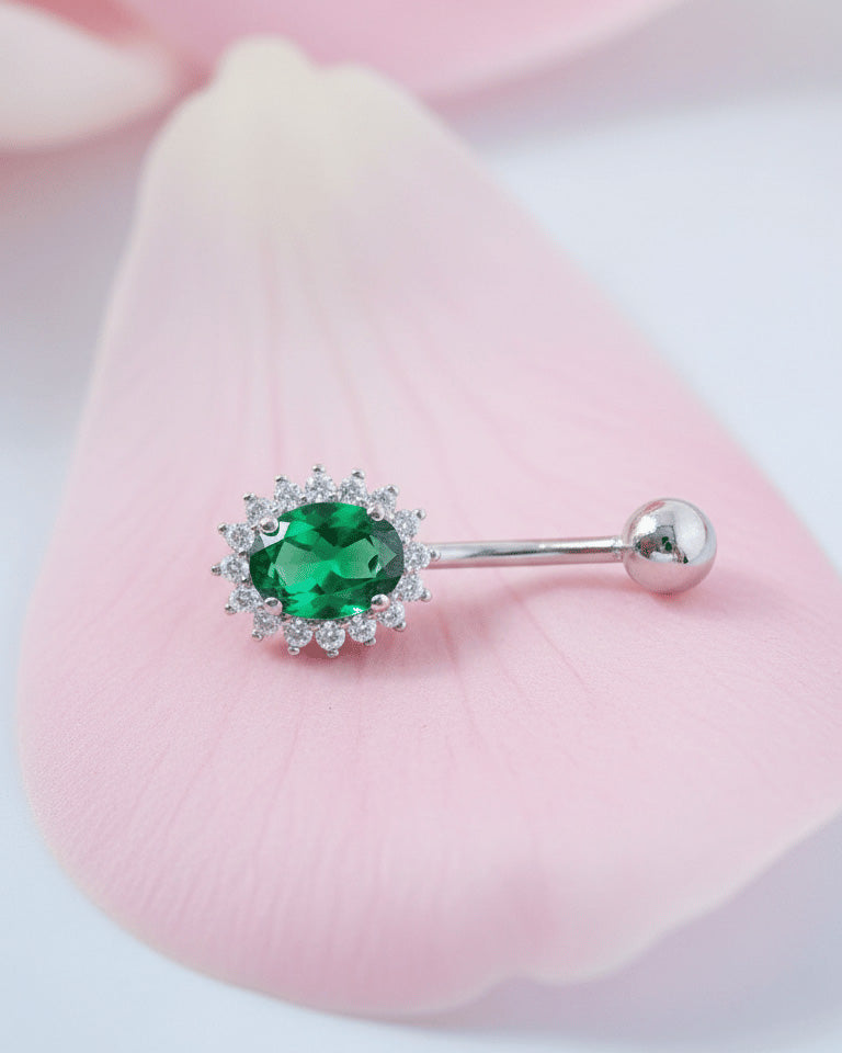 Oval emerald and sapphire color CZ in halo setting belly piercing.