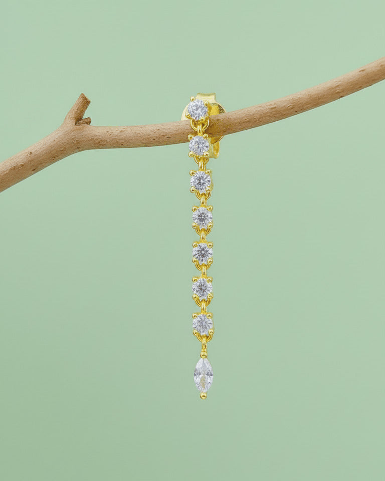 line of delicate links with round CZ ends with a marquise shape stud earring.