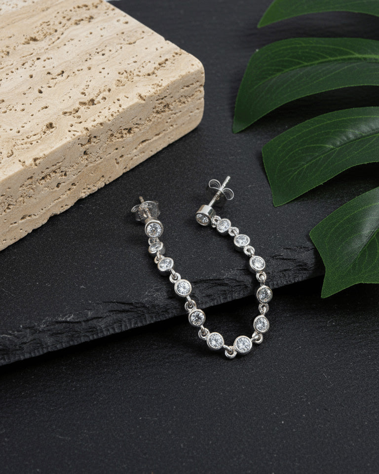 double stud earring of round stones in bezel setting.
