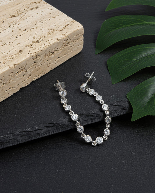 double stud earring of round stones in bezel setting.