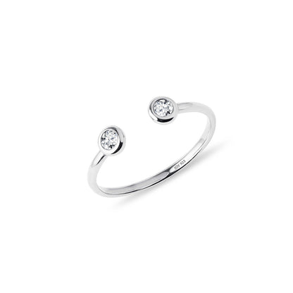 Open adjustable ring with two bezel stones.