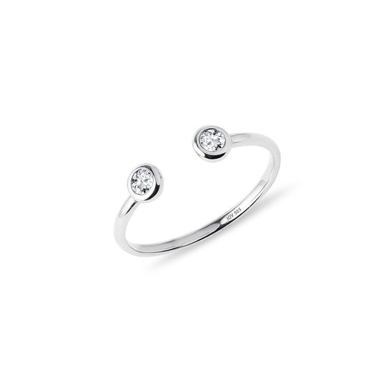 Open adjustable ring with two bezel stones.