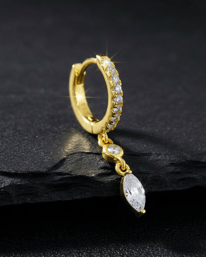 CZ huggie hoop with dangling white and emerald color stones.